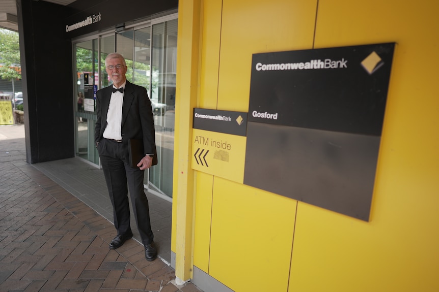 Michael Sanderson stands outside a Commonwealth Bank