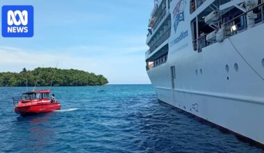 Coral Adventurer passengers begin journey home as cruise ship remains stranded on PNG reef