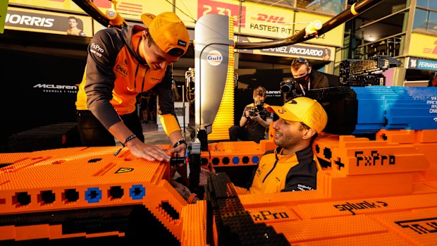 Daniel Ricciardo, McLaren, and Lando Norris, McLaren, with a Lego F1 car.