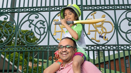 Nikhil Kulkarni with his daughter Neeti, 6, at the gates to SCG. He is teaching his daughter how to play and sharing his love of the game.