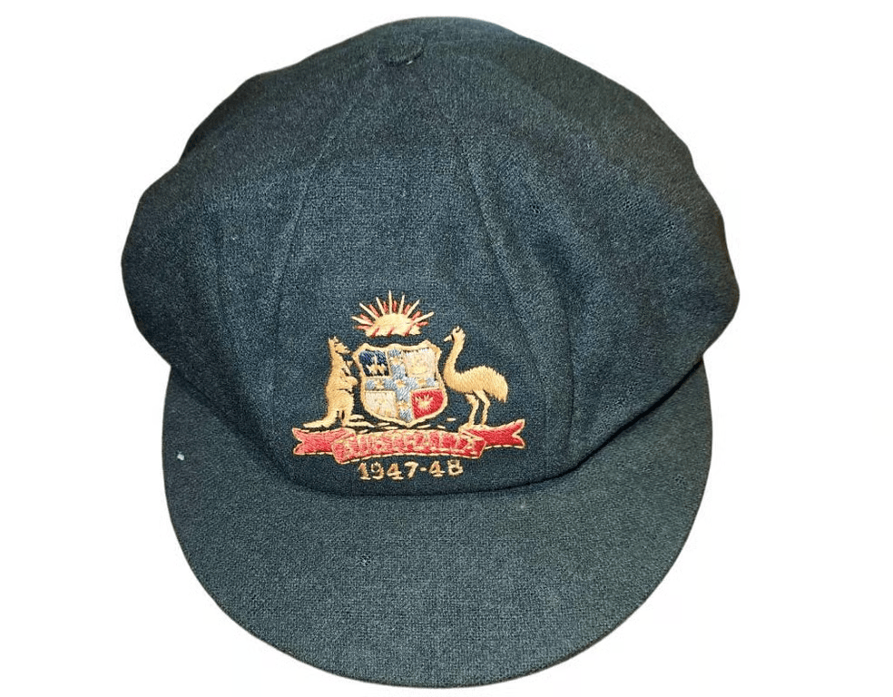 A close up shot of a cricket cap with the Australian coat of arms on it.