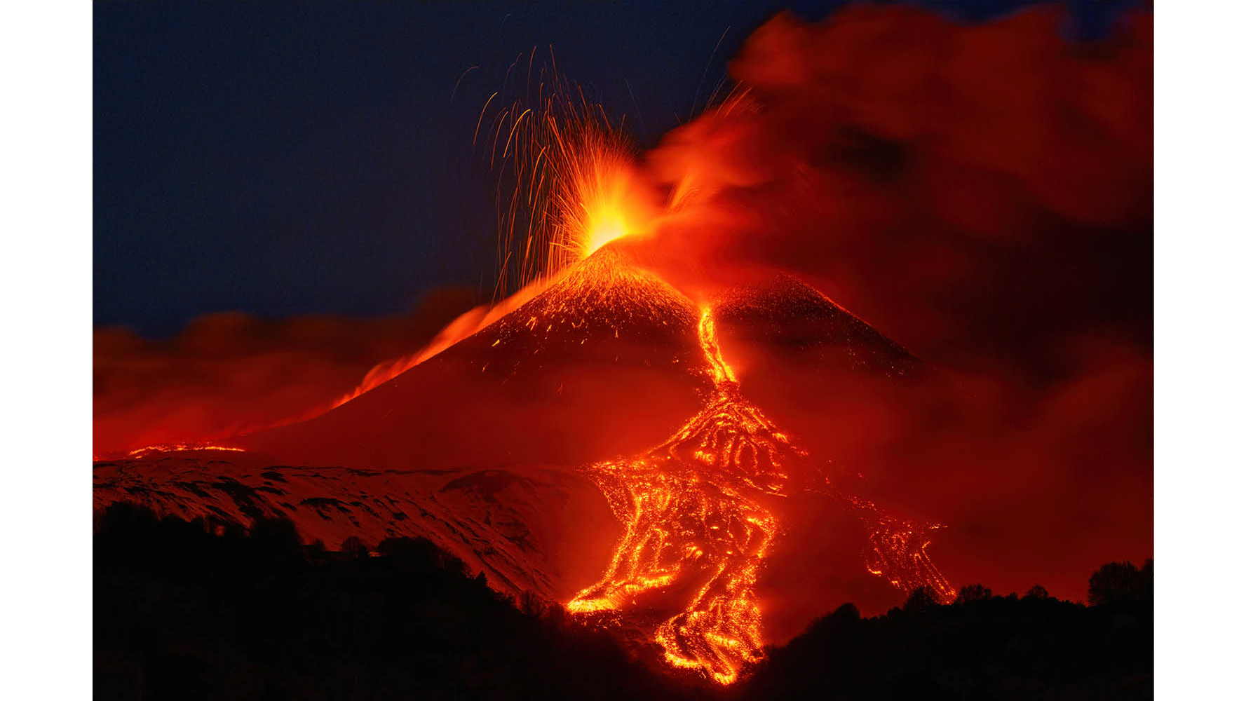Photograph titled Edna's Paroxysm, taken by Gianluca Gianferrari and the Grand Prize winner of the Hamdan bin Mohammed bin Rashid Al Maktoum International Photography Award (HIPA) 2025. Description reads: Above Sicily's Etna Volcano, glowing lapilli erupt against a snowy backdrop, and thus creating a striking contrast. The fiery bursts settle on fresh snow, forming a kaleidoscope of colors under the night sky. This is a testament to the unpredictable beauty of nature, where destructive power merges with serenity in a fleeting embrace that is eternally captured by the lens of the camera.