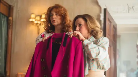 Left Bank Pictures/ITV Natalie Dormer as the then Duchess of York with Mia McKenna-Bruce as her dresser Jane Andrews, looking at a jacket