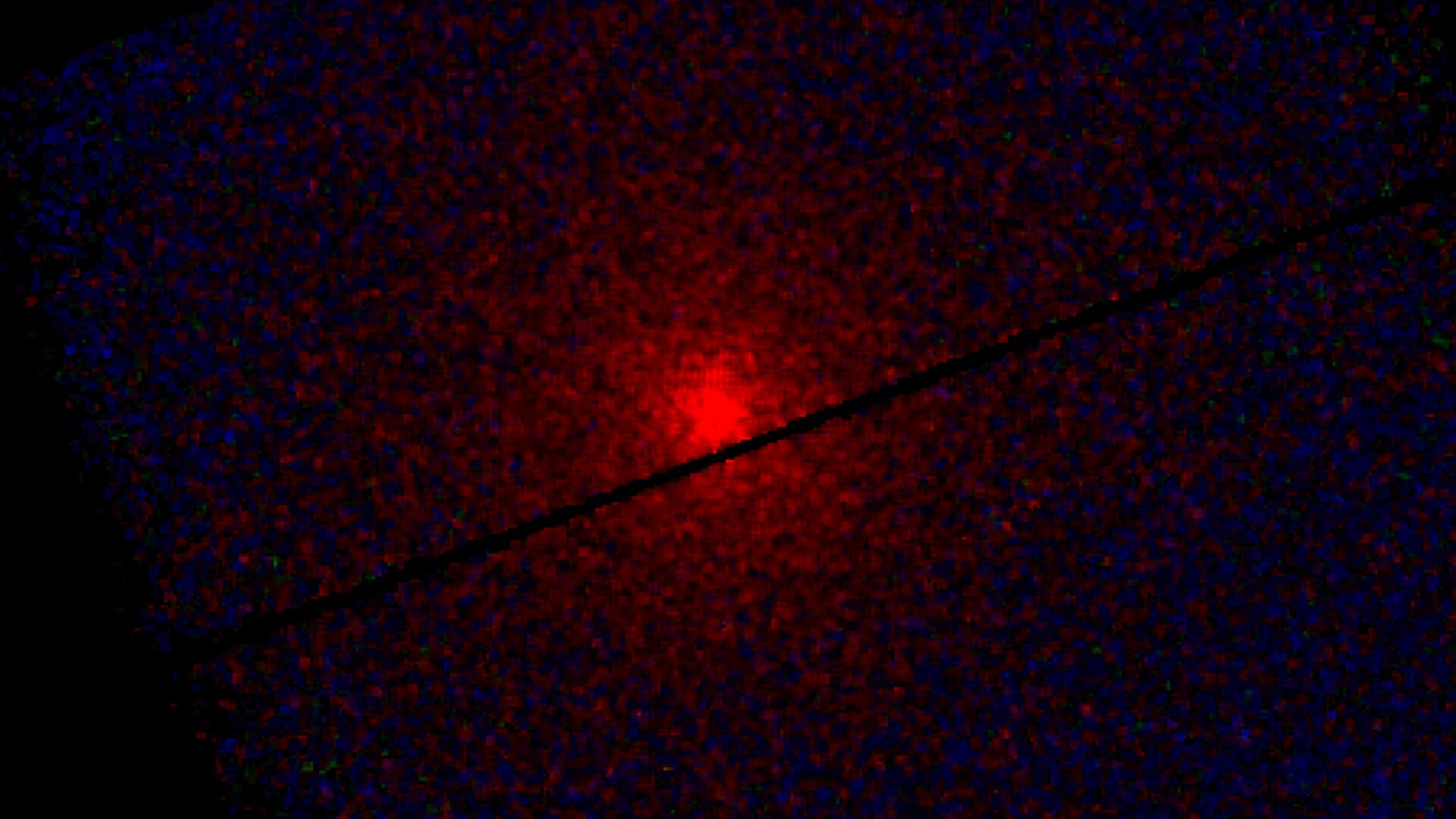 A red glowing light surrounded by black edges with cracks of black throughout the image