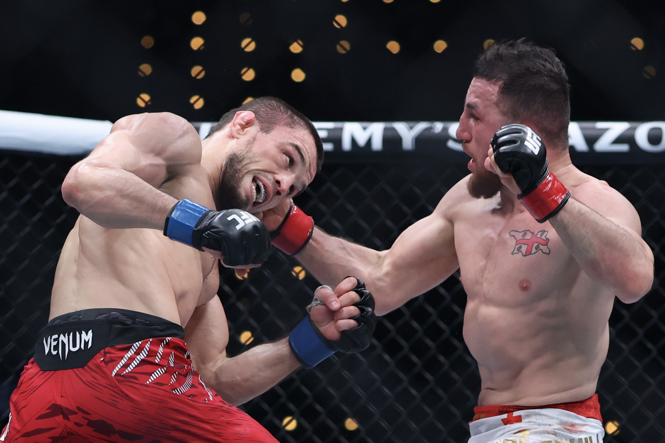 INGLEWOOD, CALIFORNIA - JANUARY 18: Merab Dvalishvili of Georgia punches Umar Nurmagomedov of Russia in a bantamweight title fight during UFC 311 at Intuit Dome on January 18, 2025 in Inglewood, California. (Photo by Harry How/Getty Images)