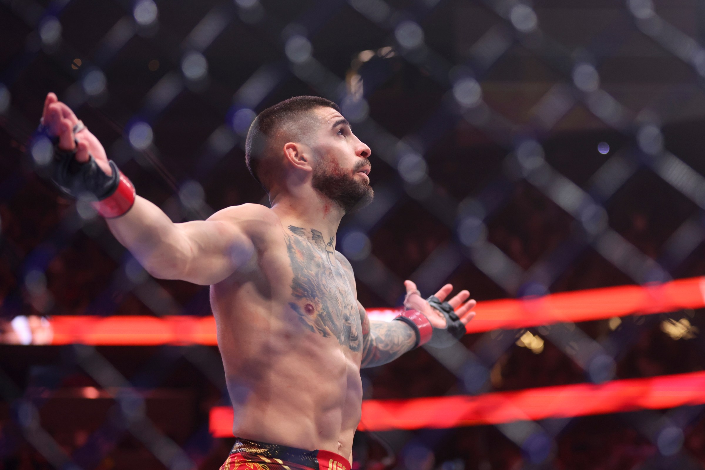 LAS VEGAS, NEVADA - JUNE 28: Ilia Topuria of Georgia celebrates after his victory via knock out against Charles Oliveira of Brazilduring a lightweight title bout at UFC 317 at T-Mobile Arena on June 28, 2025 in Las Vegas, Nevada. (Photo by Ian Maule/Getty Images)