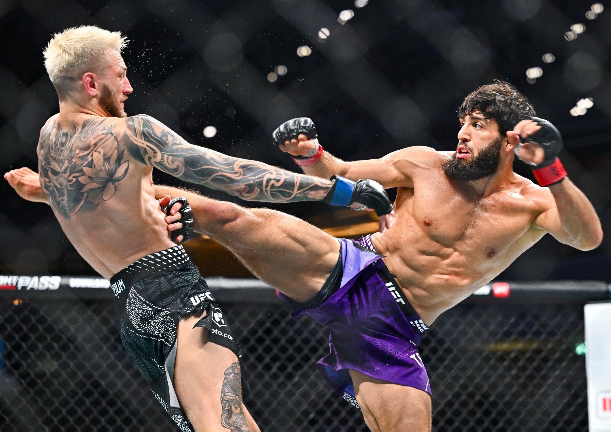 Arman Tsarukyan of Georgia kicks Dan Hooker of New Zealand in a lightweight bout during the UFC Fight Night event at Ali Bin Hamad Al Attiyah Arena (ABHA Arena) in Doha, Qatar, on November 22, 2025. (Photo by Noushad Thekkayil/NurPhoto via Getty Images)