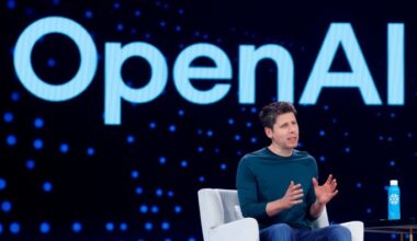 Sam Altman speaks on stage in front of a large OpenAI logo during Snowflake Summit 2025, gesturing with his hands.
