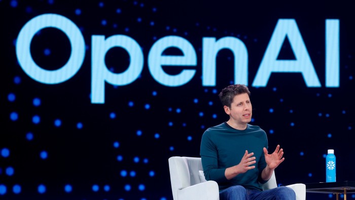Sam Altman speaks on stage in front of a large OpenAI logo during Snowflake Summit 2025, gesturing with his hands.
