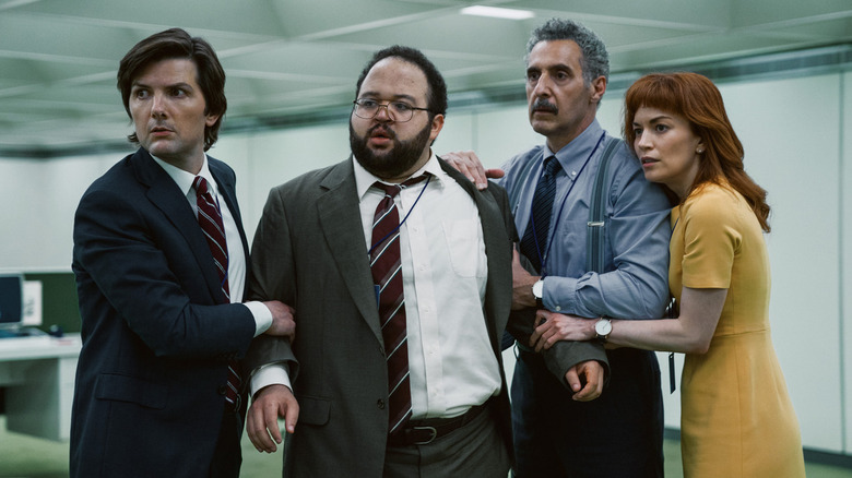 Adam Scott's Mark, Britt Lower's Helly, Zach Cherry's Ryan, and John Turturro's Irving looking concerned on Severance
