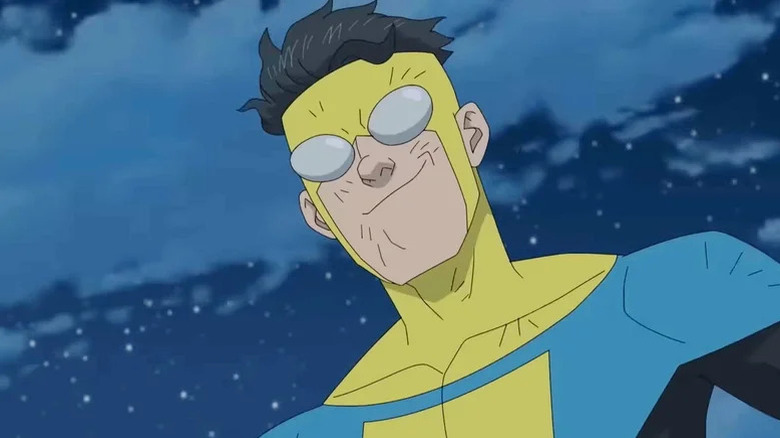 A dirtied Mark Grayson (Steven Yeun) smirks in the sky in his superhero costume in Invincible