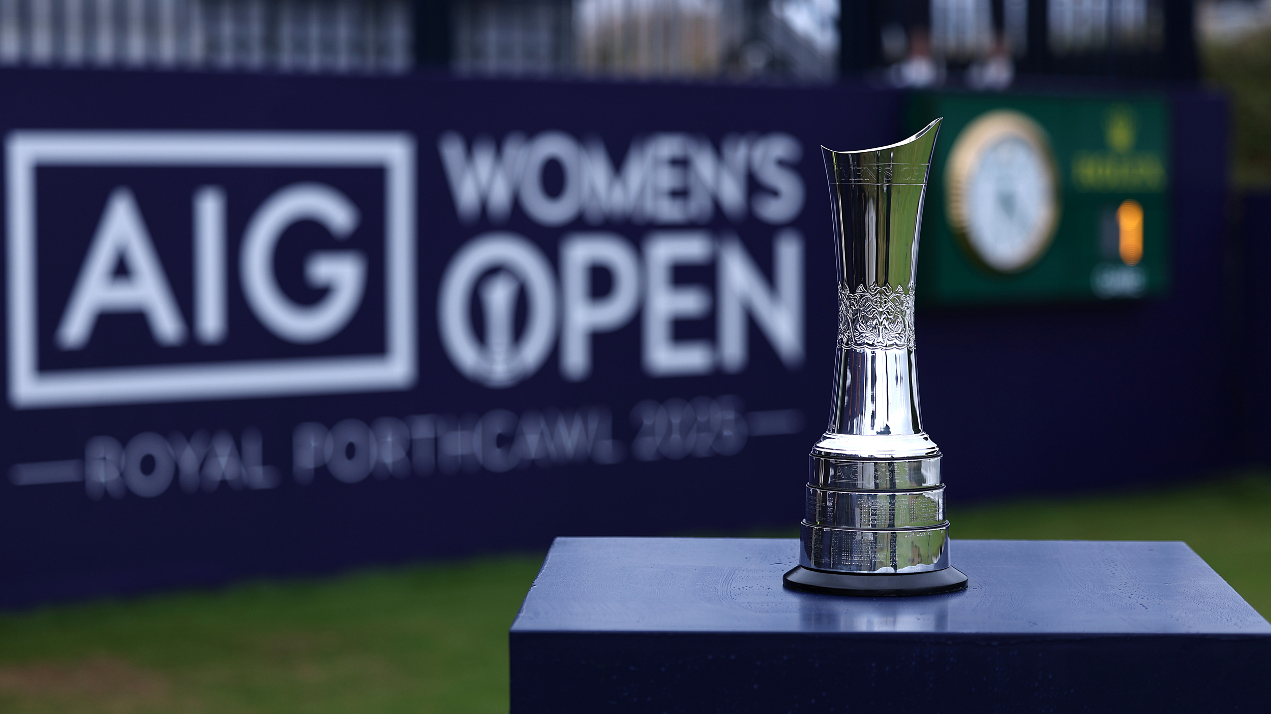 The AIG Women's Open trophy in front of AIG Women's Open signage on the 1st tee