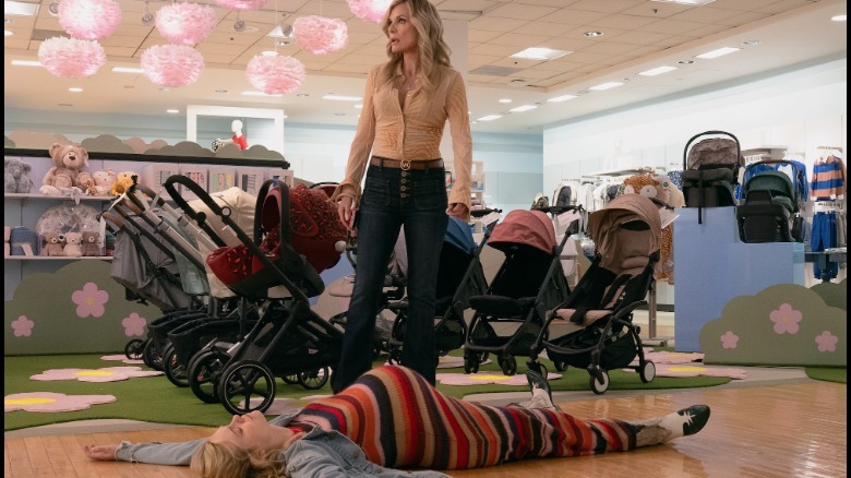 Michelle Pfeiffer stands over Elle Fanning