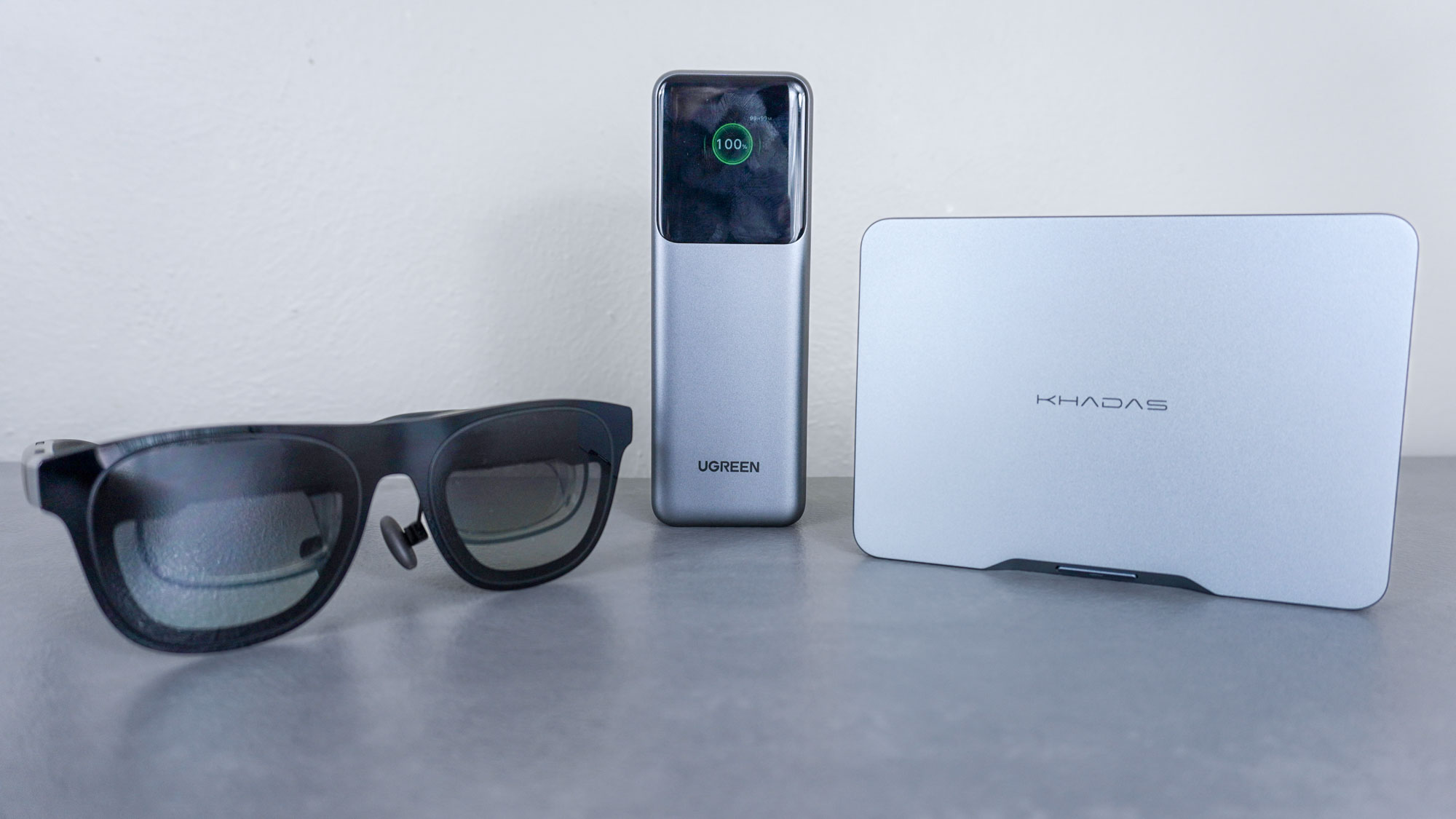 The Xreal One AR glasses next to the Ugreen Nexode Power Bank and the Khadas Mind 2S on a desk