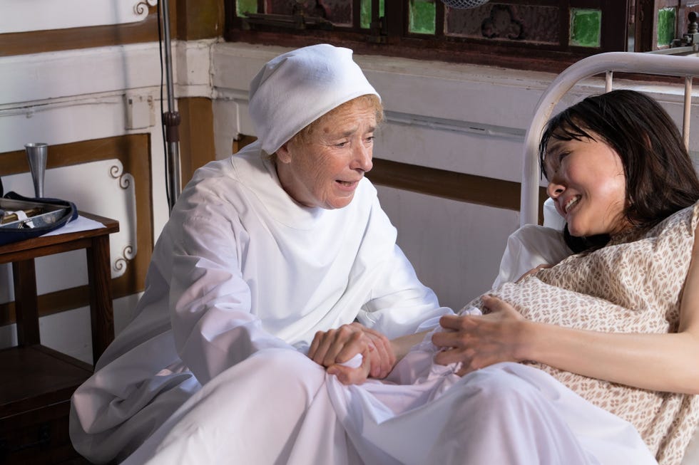 linda bassett as nurse crane tending to a pregnant yue chan played by ocean on in call the midwife christmas special 2025.jpg