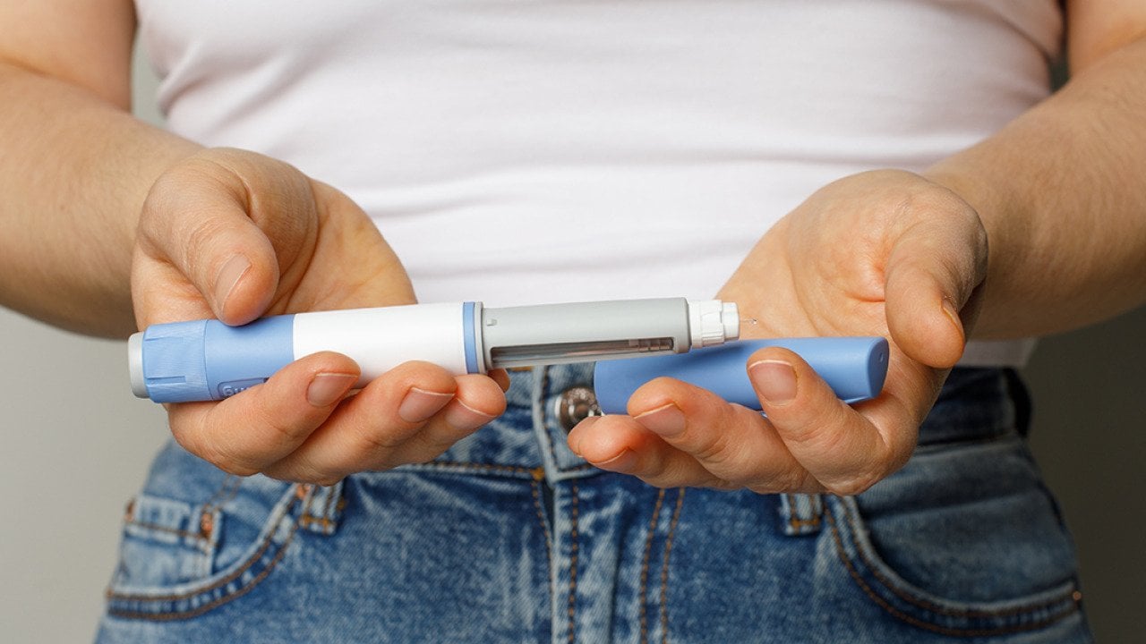 Person holding a Semaglutide pen.