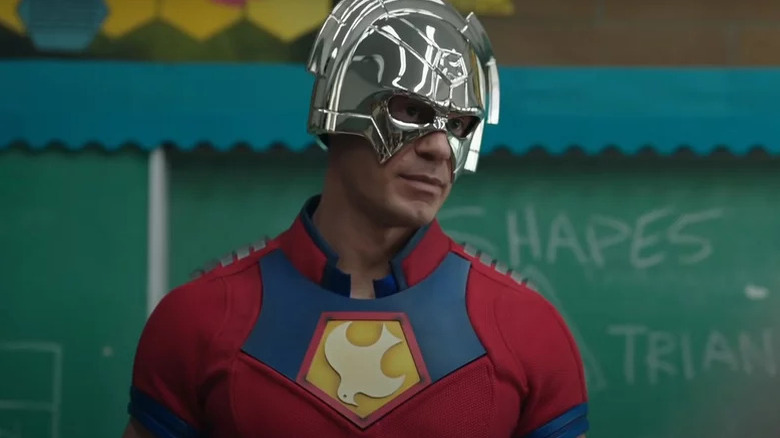 Peacemaker (John Cena) stands in an elementary school classroom in Peacemaker