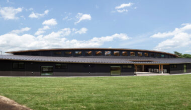 twin leaf-shaped roofs unfold atop nursery school by NIKKEN SEKKEI in japan