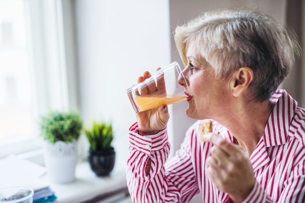 Senior woman drinking juice