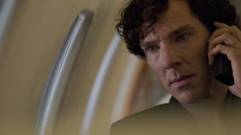 Benedict Cumberbatch as Sherlock Holmes is surprised by an in-flight video in an episode of Sherlock