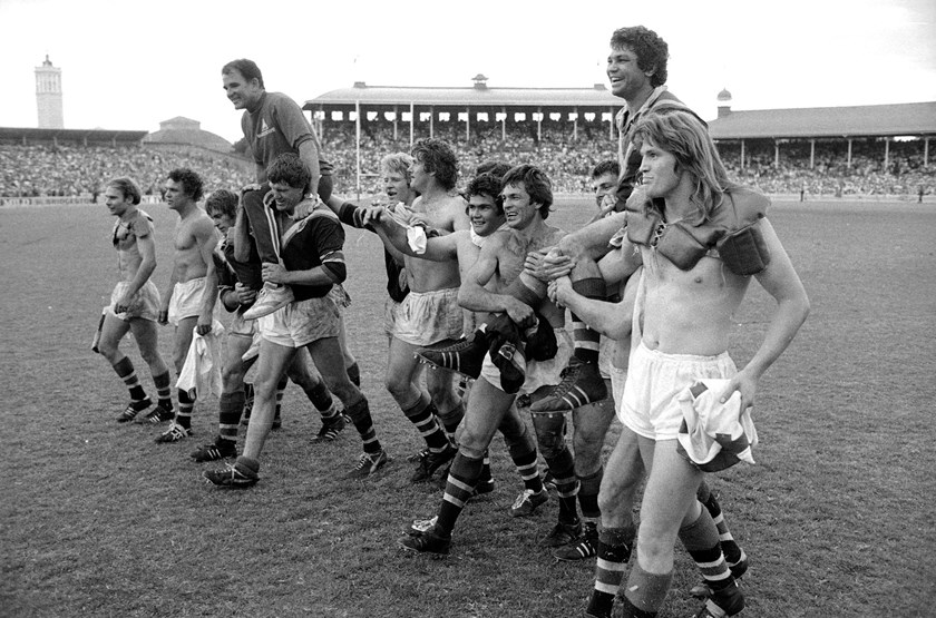 Johnny Mayes (far left) celebrates the 1975 premiership with Roosters teammates and legendary coach Jack Gibson.