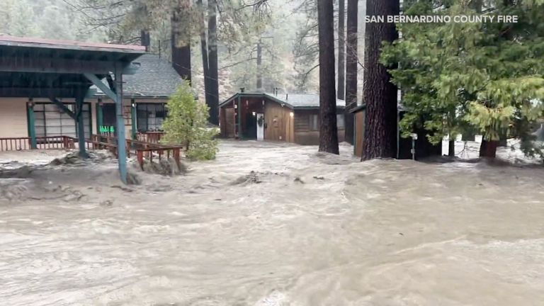 Houses and trees partially submerged after torrential rain. Pic: San Bernardino County Fire/AP