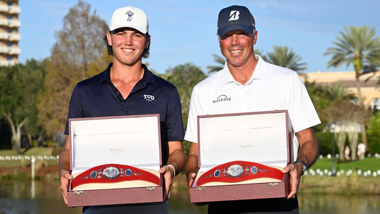 Matt Kuchar and his son Cameron Kuchar hold the championship belts after winning the PNC Championship (AP Photo/Phelan M. Ebenhack)