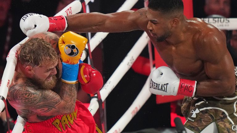 Anthony Joshua punches Jake Paul during their heavyweight boxing match