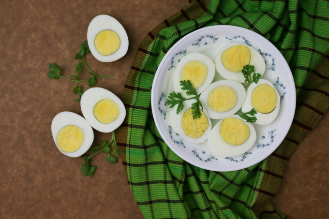 Sliced boiled eggs on a white plate. Illustration photo by Unsplash
