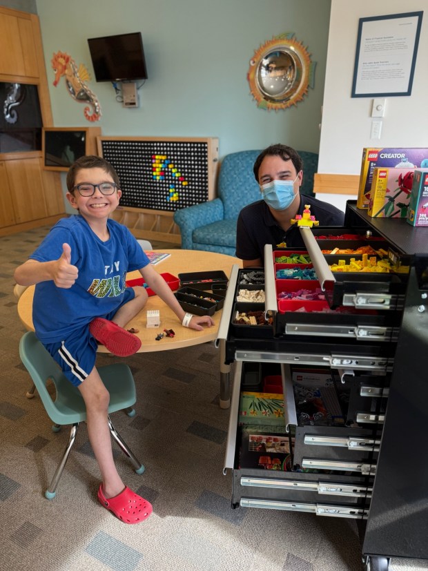 Henry Neligon is all smiles as he checks out Yale Haven Children's Hospital Child Life's new program, Bedside Builders, with Tyler Mahoney, Child Life gaming and technology specialist. (Contributed photo)