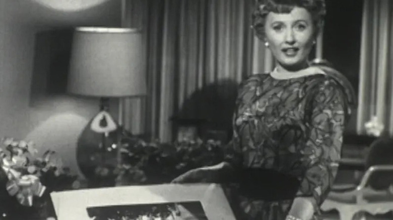 Barbara Stanwyck in dress holding picture (not visible) in The Barbara Stanwyck Show