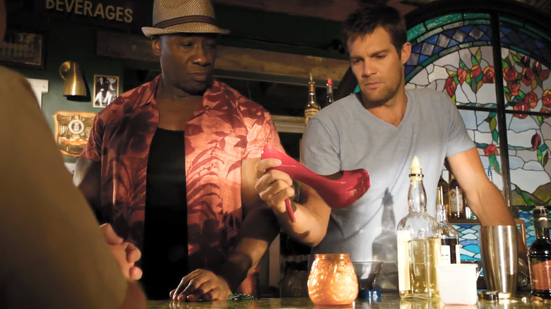 Michael Clarke Duncan's Leo Knox and Geoff Stults' Walter Sherman looking at a stiletto in The Finder