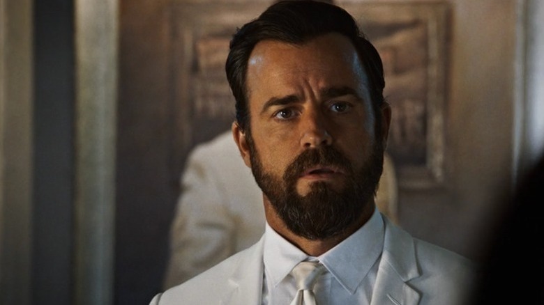 Kevin Garvey (Justin Theroux) stands surprised in a white suit in The Leftovers