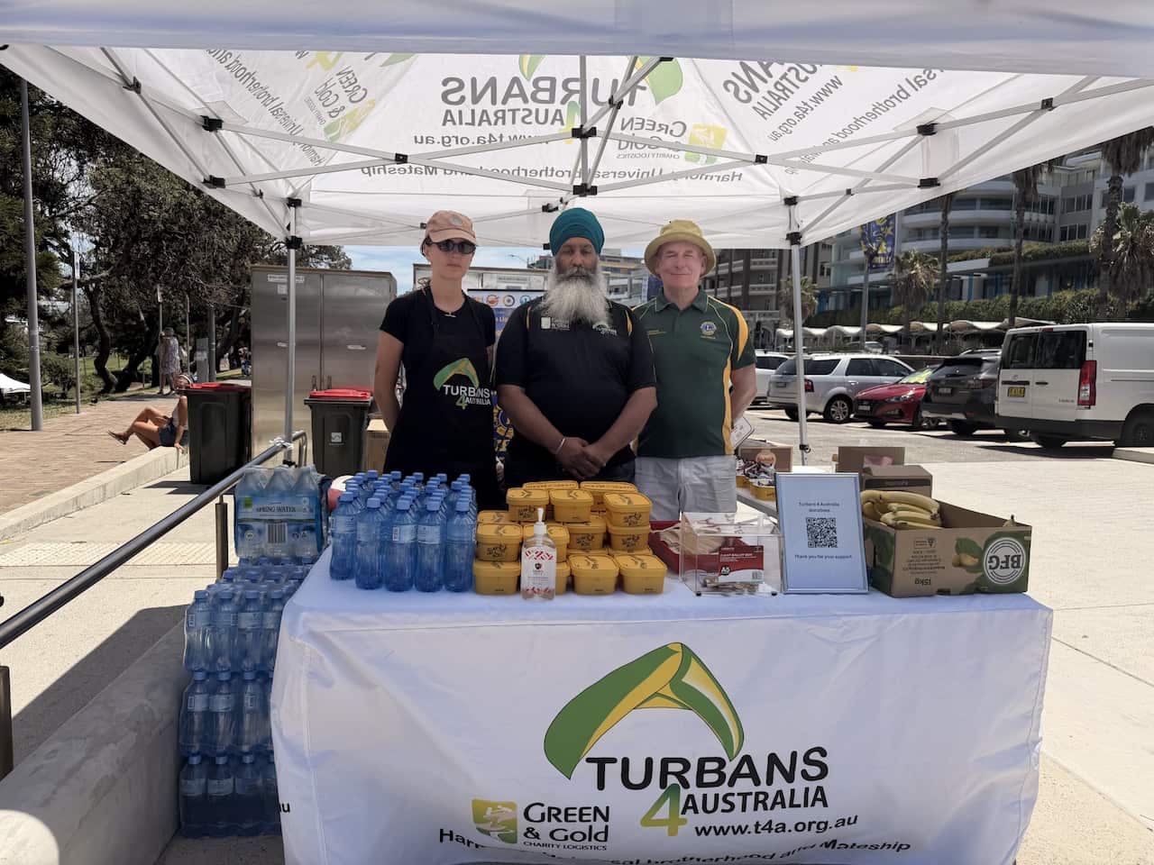 3 men standing in front of a table that reads Turbans 4 Australia