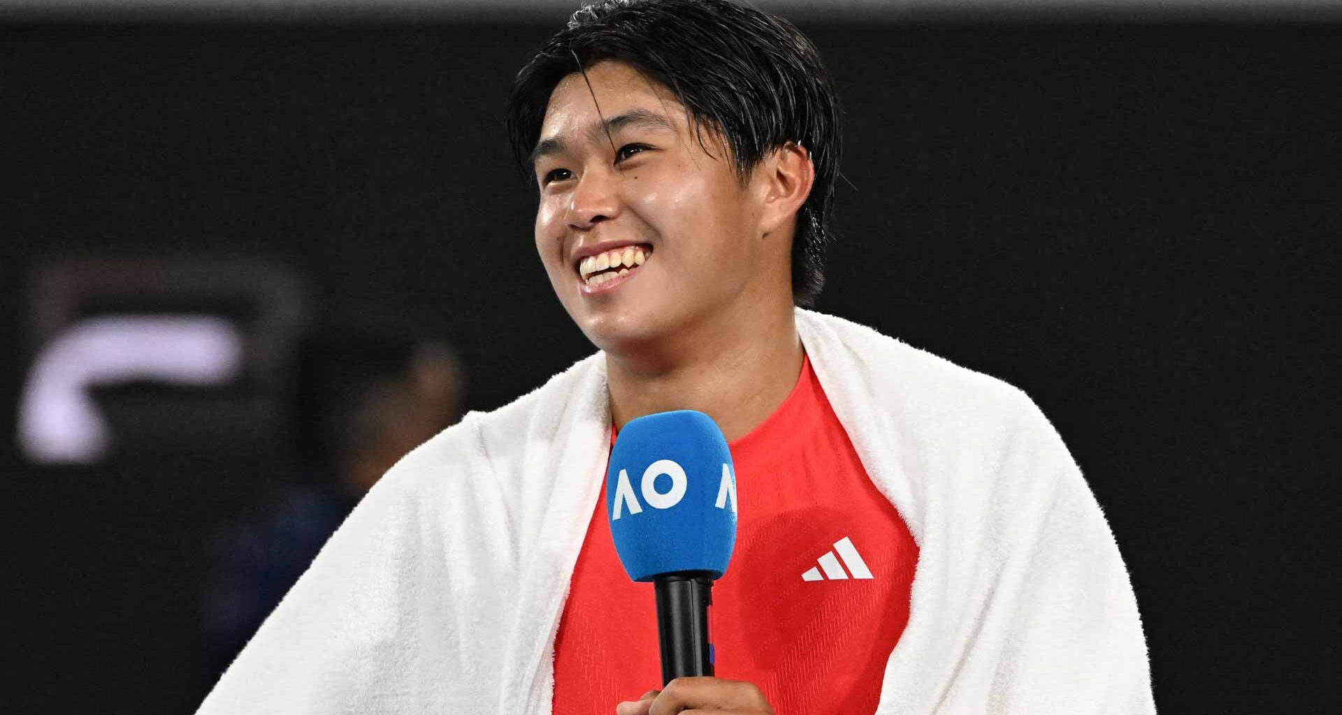 Learner Tien smiles after his dramatic five-set victory against Daniil Medvedev at the Australian Open.