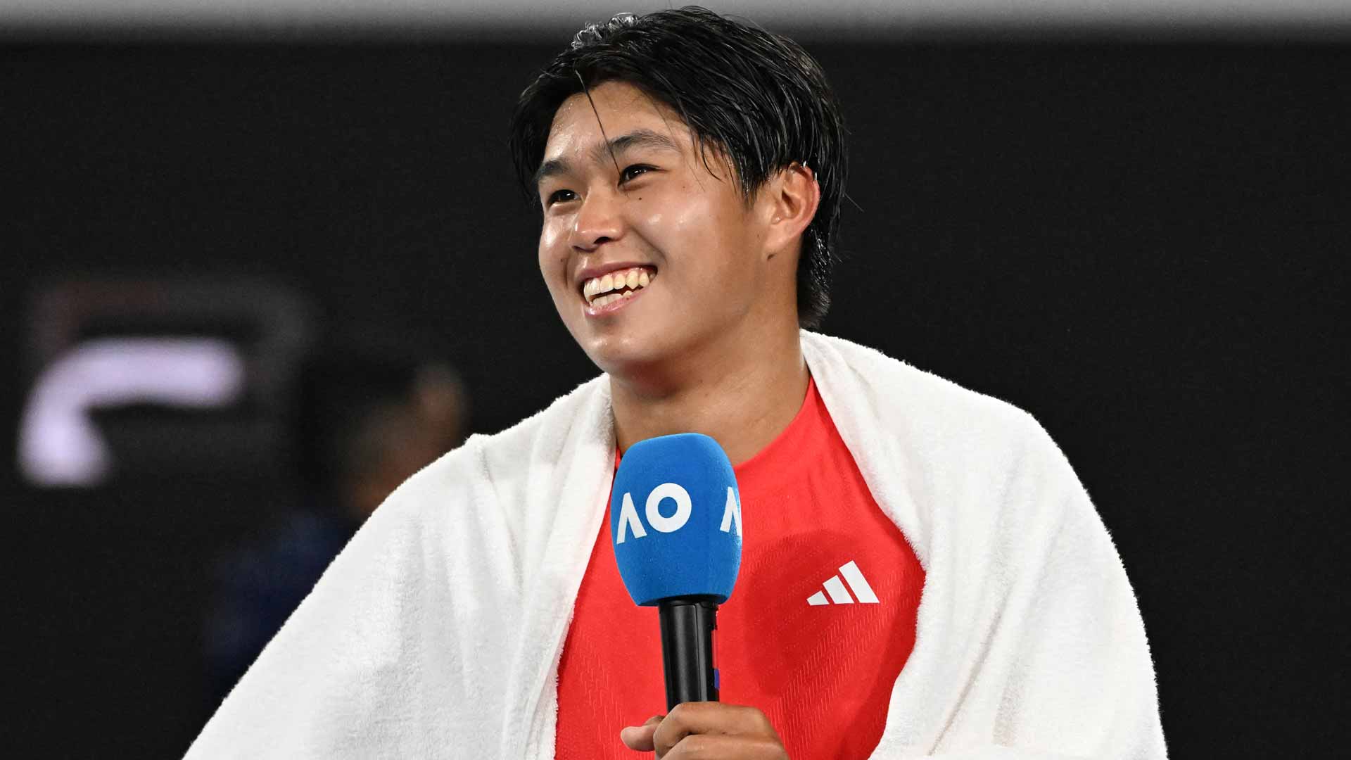 Learner Tien smiles after his dramatic five-set victory against Daniil Medvedev at the Australian Open.