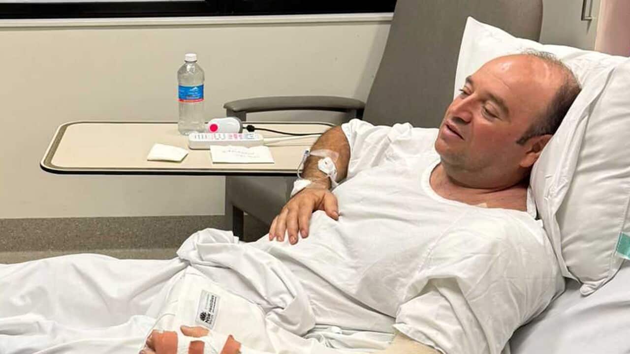 Ahmed Al-Ahmed in a hospital bed