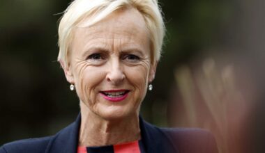 A middle-aged white woman with short blonde hair