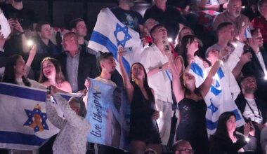 Fans cheer as they wave Israeli flags