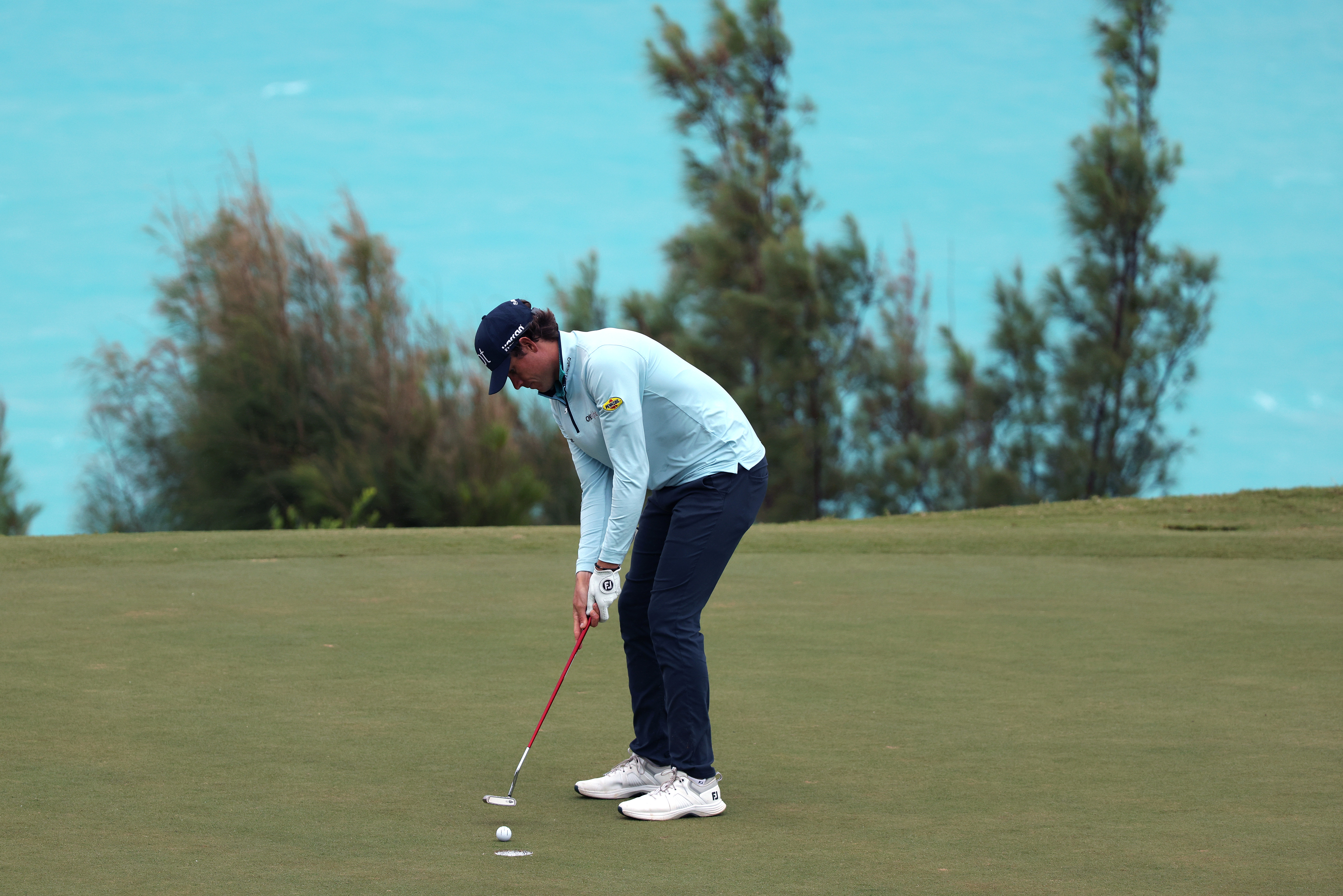 Adam Schenk hits a putt