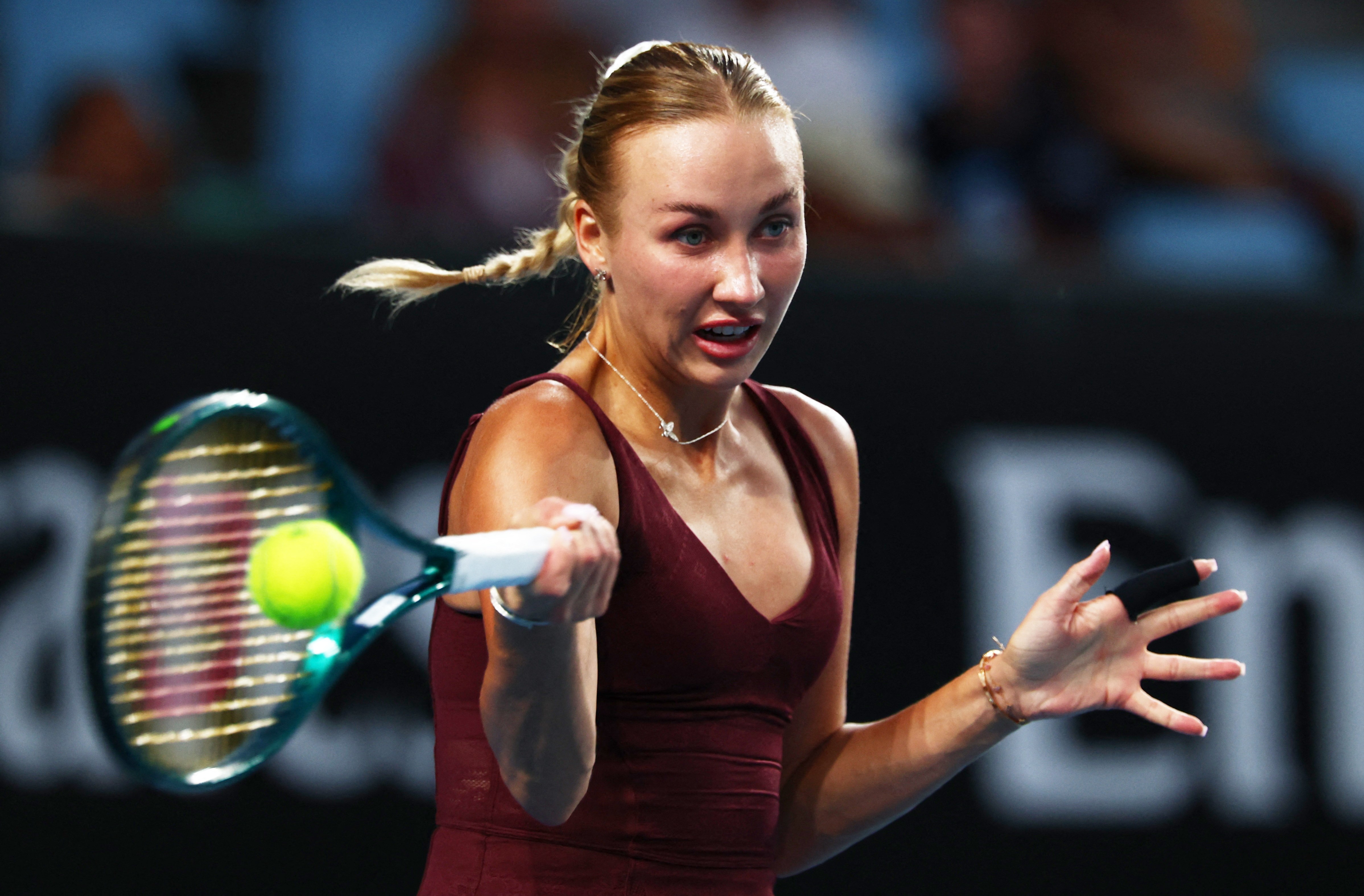 Anastasia Potapova hitting a tennis ball during her match at the Australian Open.