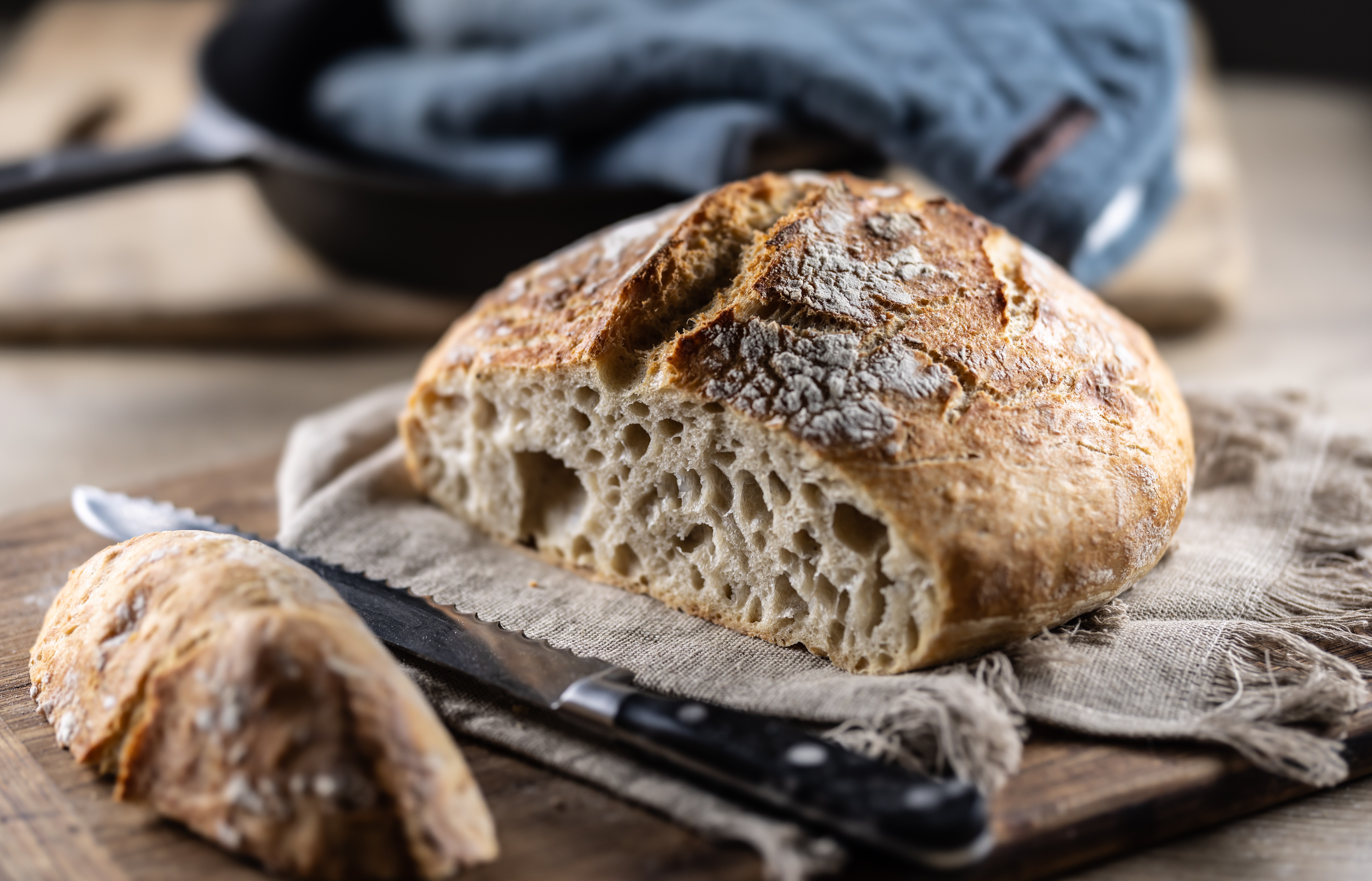 Sliced fresh sourdough bread on a cutting board.