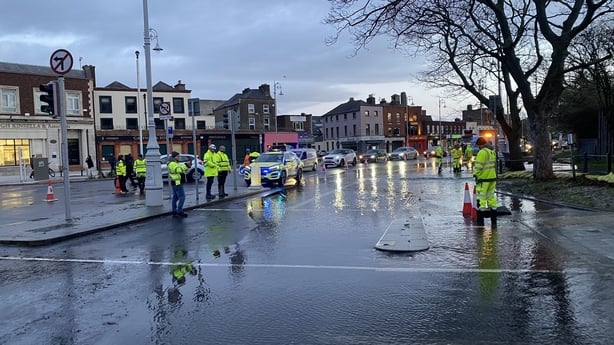 Teams work to clear flooding in Fairview as traffic builds up