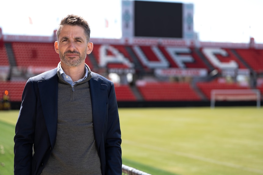 Reds Chief Executive Nathan Kosmina standing inside Hindmarsh Stadium