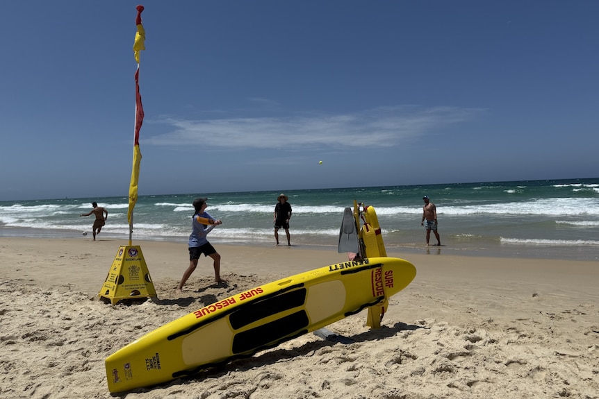Surf Lifesaving flags and board on sand