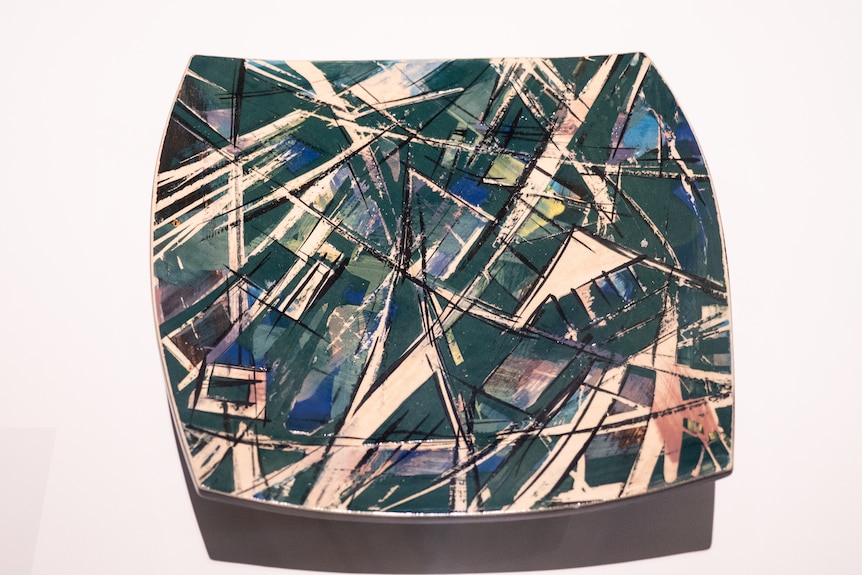 Piece of glazed porcelain in angular, flat shape with blue and green glaze