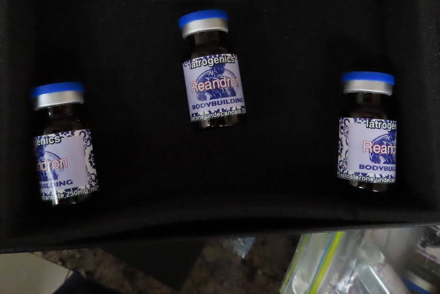 Three small bottles with the word "bodybuilding" on their labels.