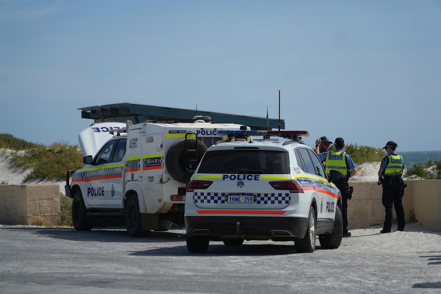 Police and police vehicle are seen at Ledge Point Beach in Ledge Point