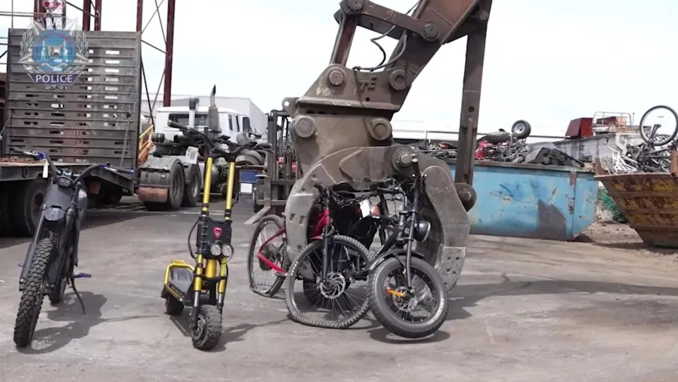 E-bikes being crushed by an excavator in Perth.