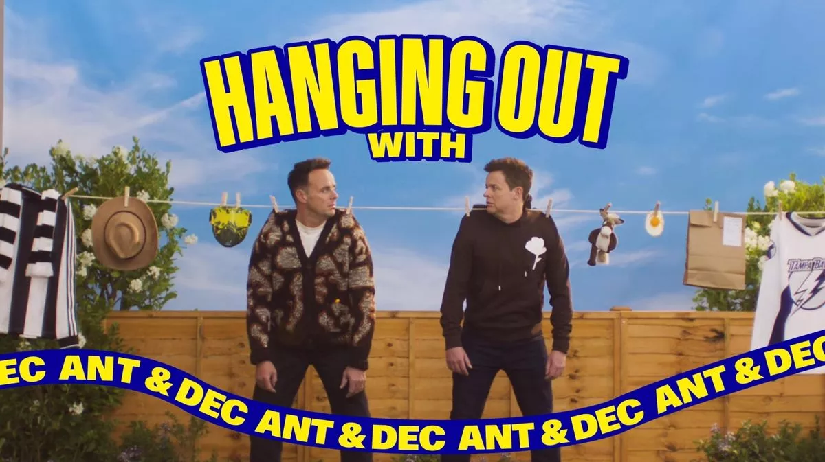 Ant and Dec sitting on a wall advertising their new podcast